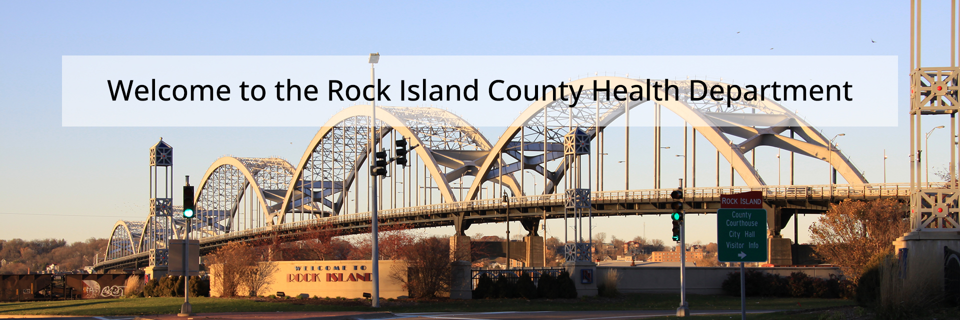 Photo of the Centennial Bridge with a Welcome to Rock Island sign in the foreground and a text overlay that says Welcome to the Rock Island Health Department