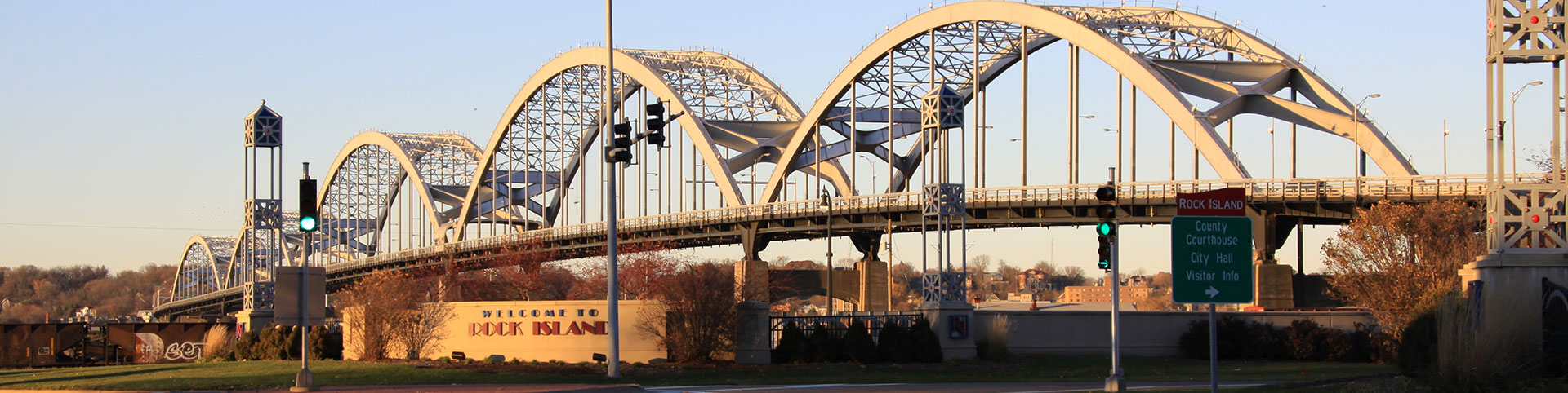 Photo of the Centennial Bridge with a Welcome to Rock Island sign in the foreground