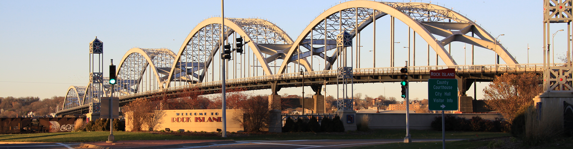 Photo of the Centennial Bridge with a Welcome to Rock Island sign in the foreground